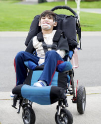 kid in wheelchair smiling